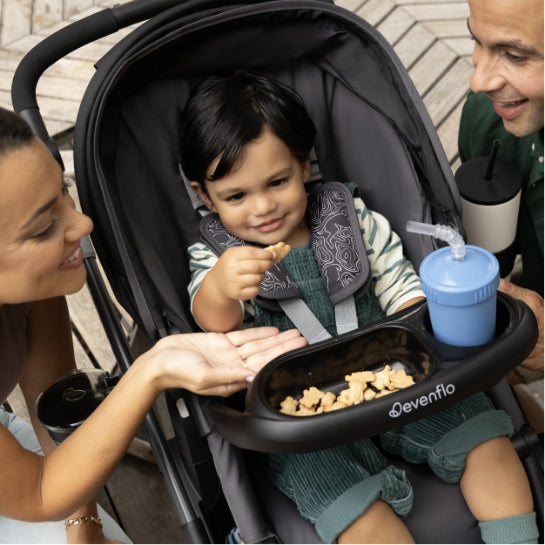 Image of child eating snacks in the child snack tray of Pivot Troop