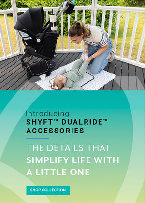 Introducing Shyft DualRide Accessories: The Details That Simplify Life with a Little One. Image of mom with baby next to Shyft DualRide with Stroller Crossbody Bag and Carryall Bag attached, and Babe on the Run Bag. Shop the Collection. 