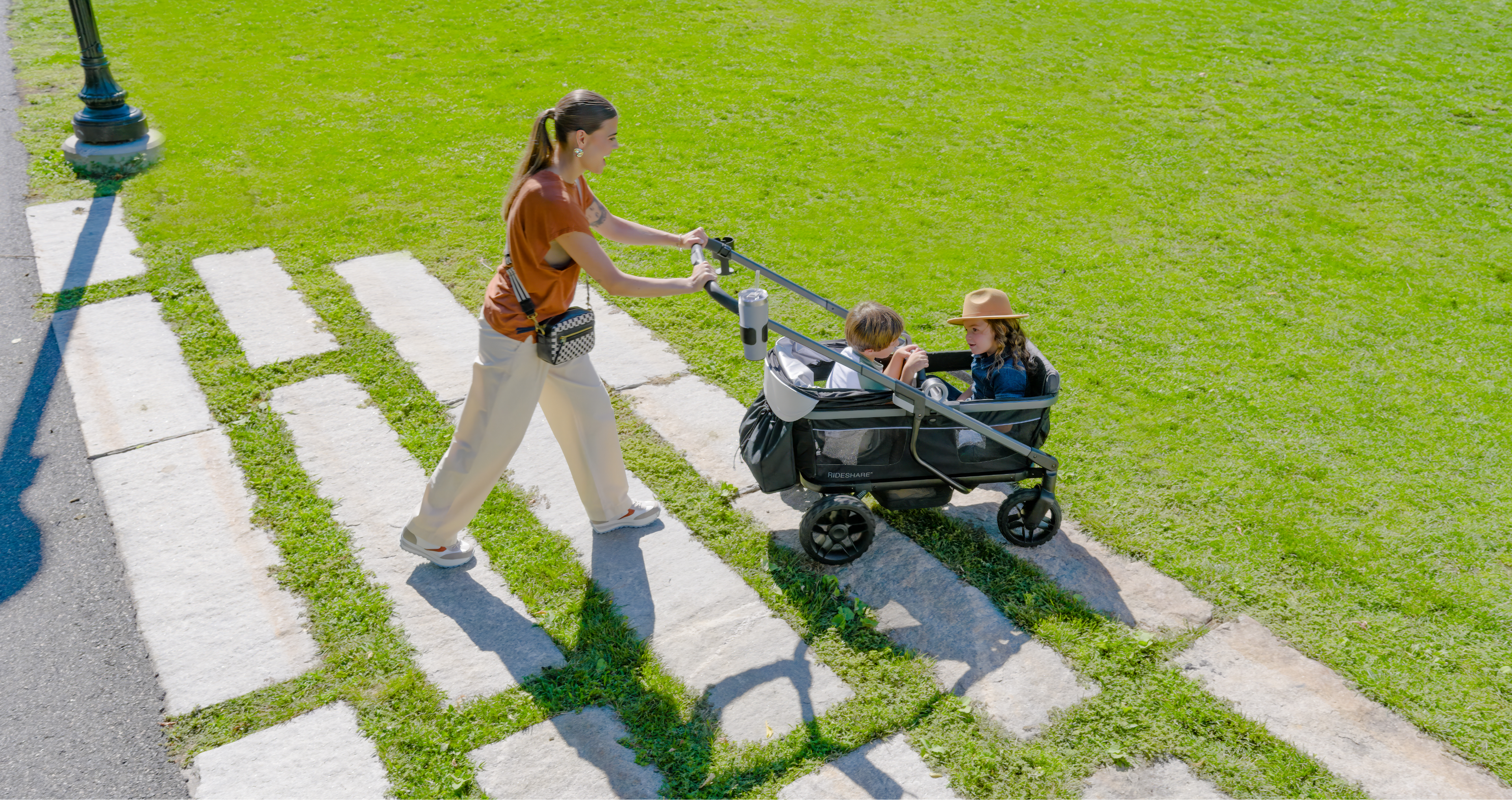 Image of mom taking two kids in Shyft Rideshare to a playground