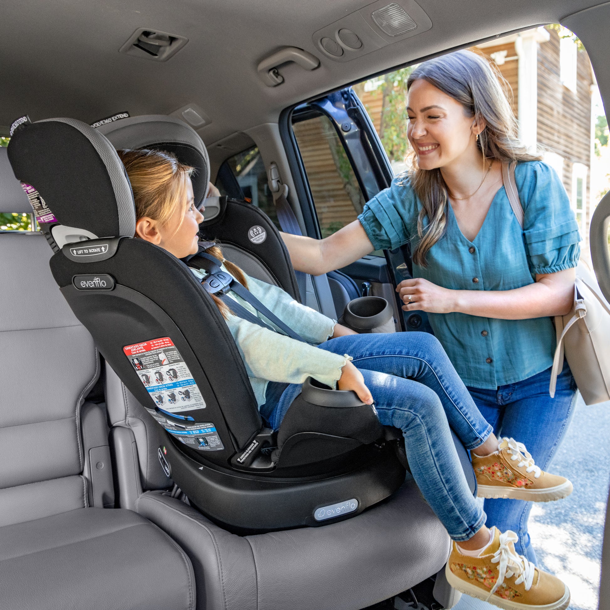 https://www.evenflo.com/cdn/shop/products/38412464_24_Revolve360_Extend_Rotational_All_In_One_Car_Seat_Revere_Lifestyle_Forward_Facing_Harness_Loading.jpg?v=1672855497&width=1946