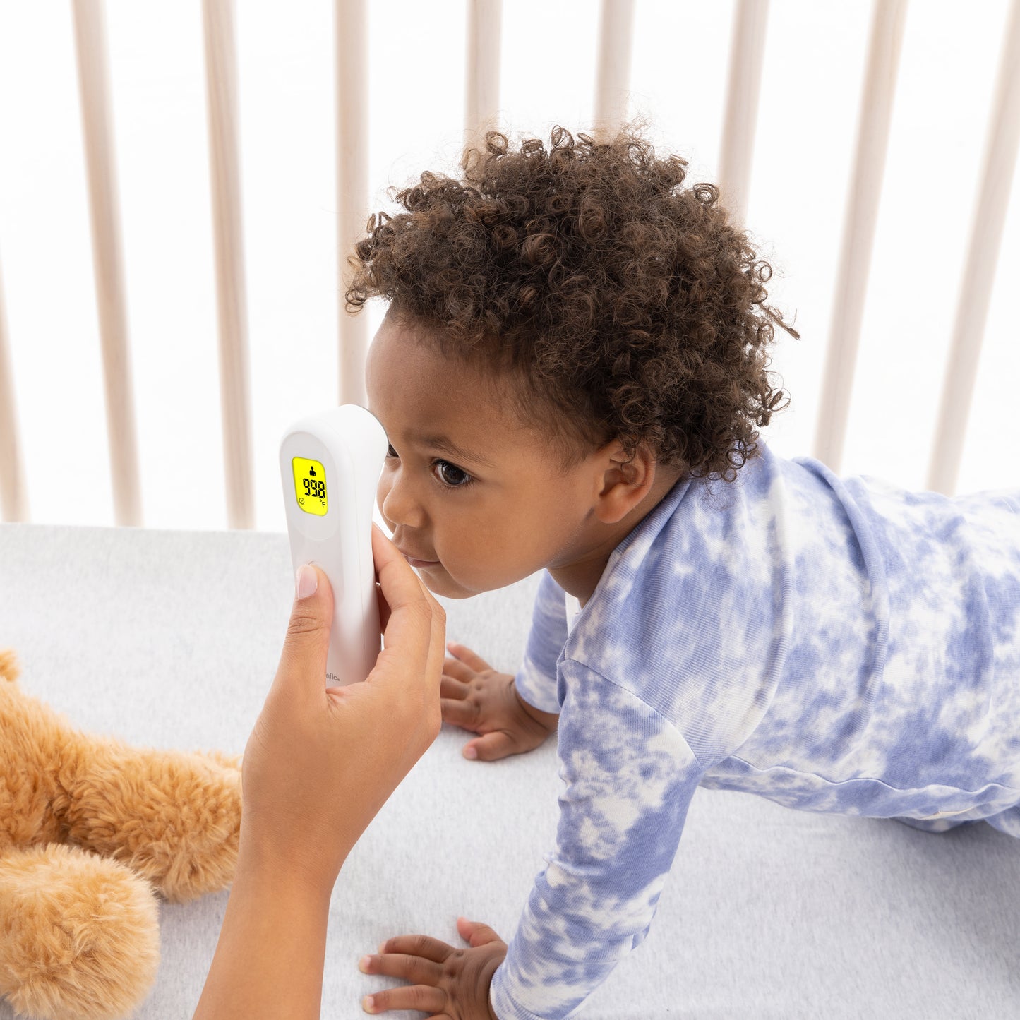 Evenflo PreciseRead Touchless Forehead Thermometer being used to take temperature